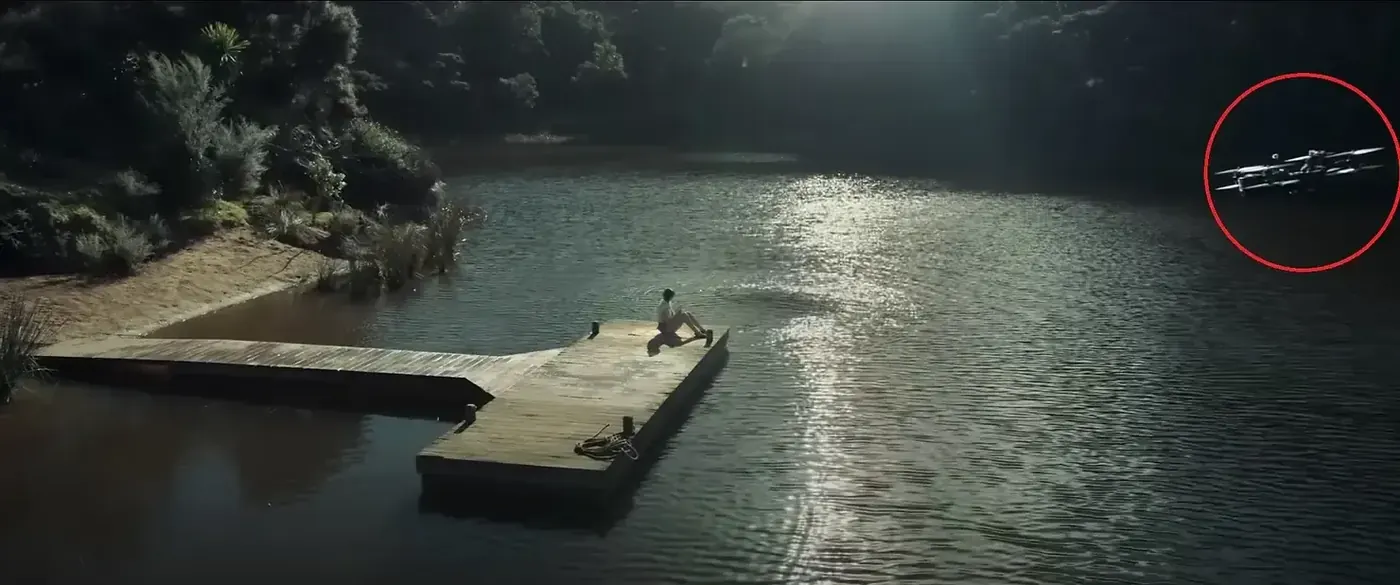 Still from Evil Dead Rise: an FPV drone, circled in red, flying over a lake toward a pier