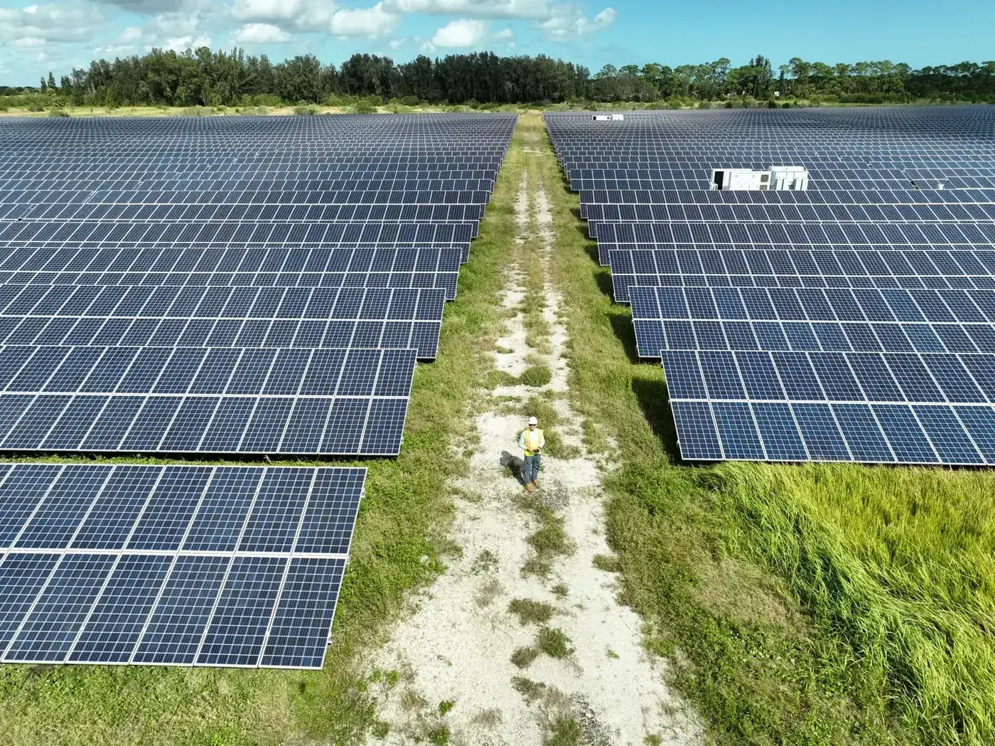 Aerial view down the center aisle of a large solar farm